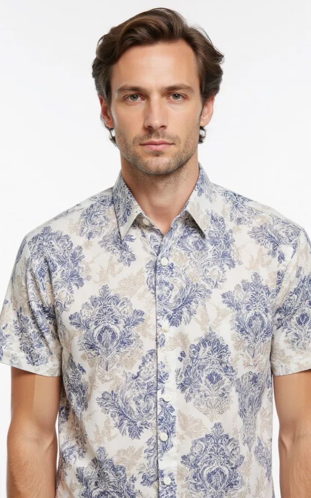 A French model wearing a Damask pattern   printed shirt, against a white background, in a front   facing bust portrait